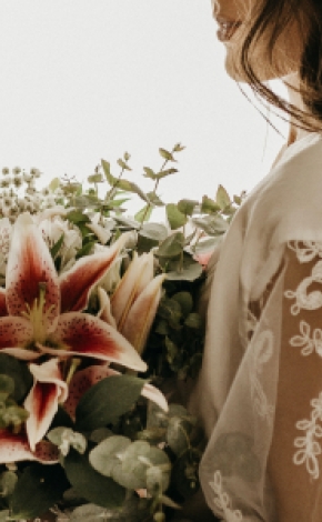 A bride holds a bouquet of flowers.