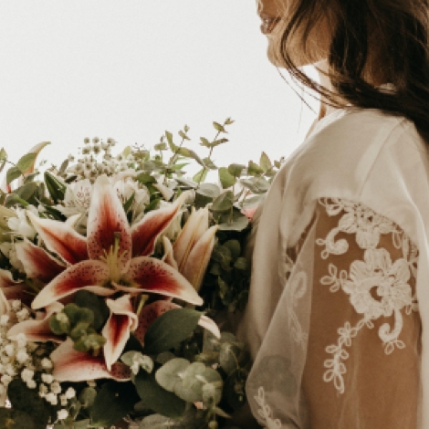 A bride holds a bouquet of flowers.