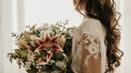 A bride holds a bouquet of flowers.
